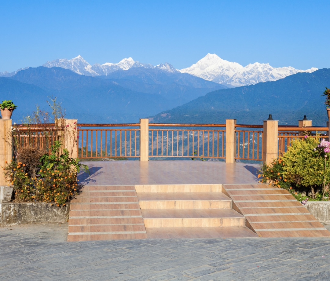 Explore Darjeeling with a full day of sightseeing, witnessing the morning sunlight cascade over the majestic Mt. Kanchenjunga.